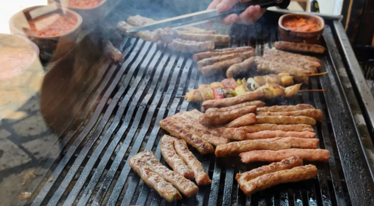 Kebapi grilling over charcoal at a Skopje grill house