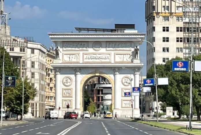 Porta Macedonia triumphal arch lit up at night in Skopje
